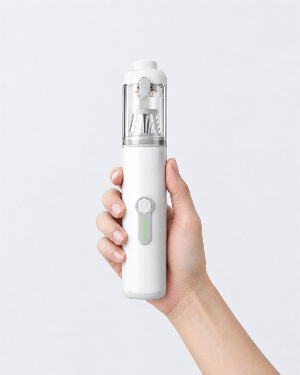 Hand holding the Plumeo white handheld vacuum