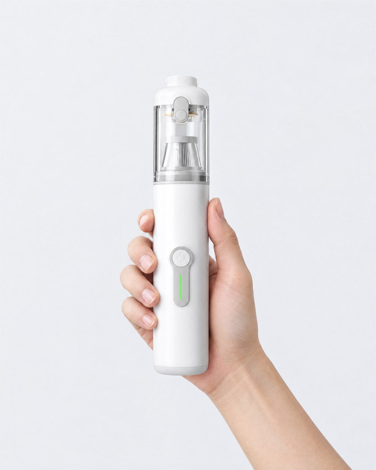 Hand holding the Plumeo white handheld vacuum